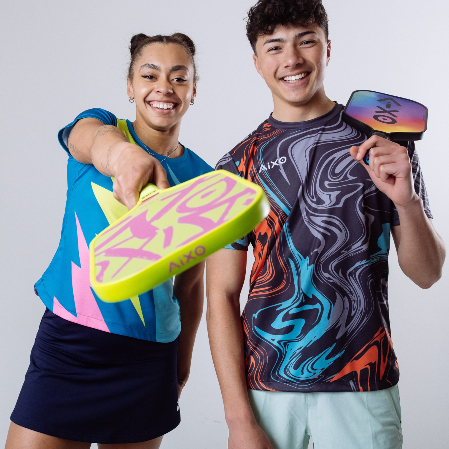 Players showing off AIXO Ghost Prism Break — a colorful pickleball racket that blends fun and high performance.